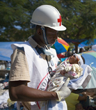 Hatian Aid worker with baby